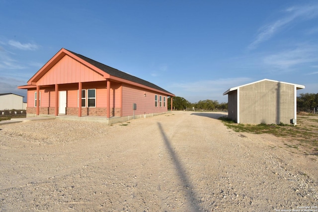 view of side of home with brick siding and driveway