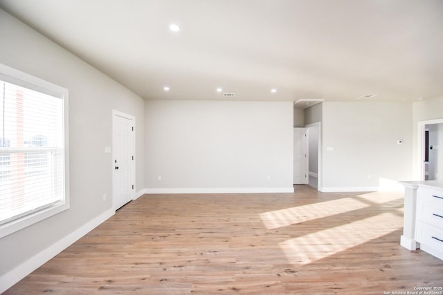 unfurnished living room with recessed lighting, baseboards, visible vents, and light wood finished floors