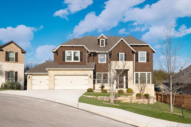 view of front of home featuring a shingled roof, concrete driveway, an attached garage, fence, and a front lawn