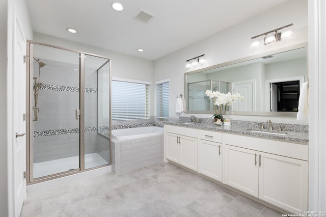 full bath featuring a garden tub, a shower stall, visible vents, and a sink