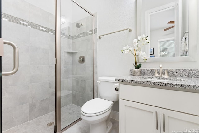 full bathroom with toilet, a shower stall, and vanity