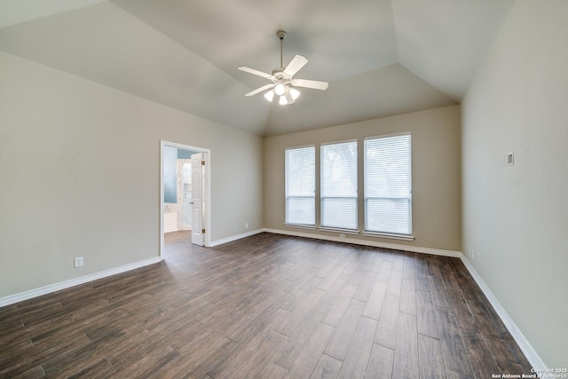 empty room with dark wood-style floors, ceiling fan, lofted ceiling, and baseboards