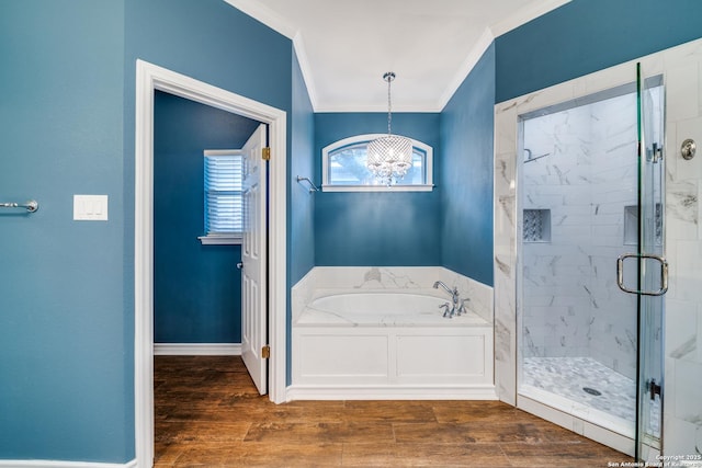 bathroom with a garden tub, crown molding, a shower stall, wood finished floors, and baseboards