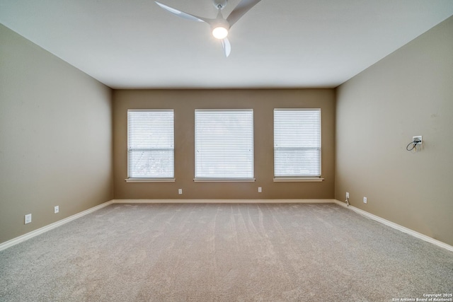 unfurnished room featuring light carpet, ceiling fan, and baseboards