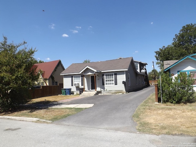 bungalow with fence and driveway