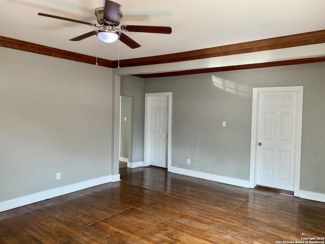 spare room with ceiling fan, dark wood finished floors, and baseboards