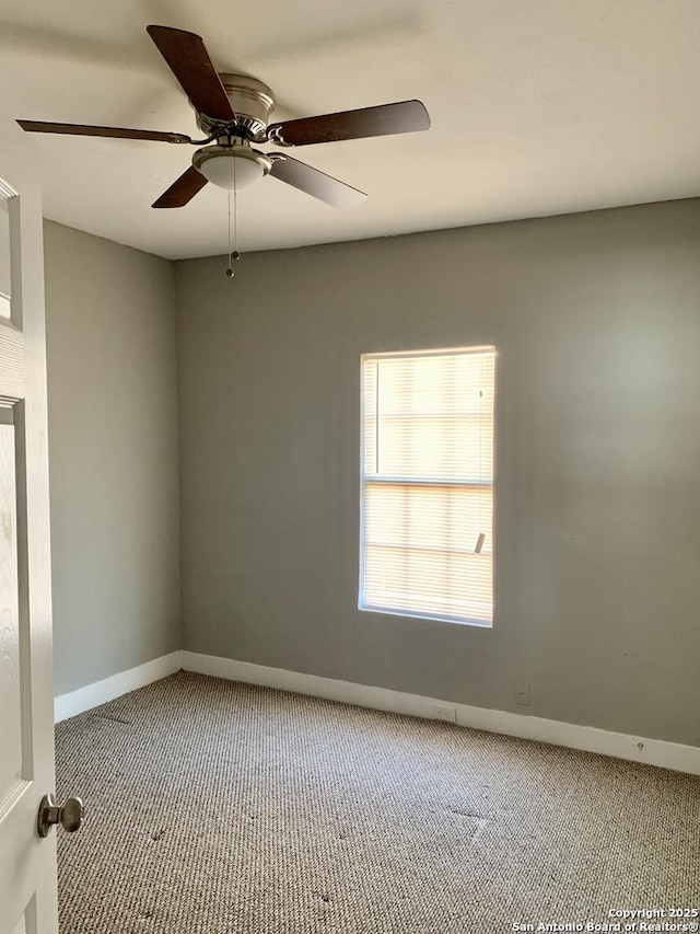 empty room featuring carpet floors, baseboards, and a ceiling fan