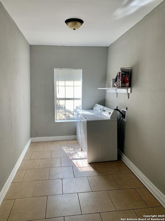 laundry area with laundry area, light tile patterned flooring, independent washer and dryer, and baseboards