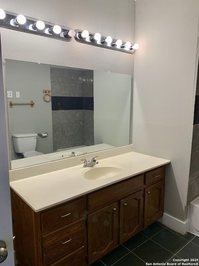 bathroom featuring vanity, toilet, and tile patterned floors