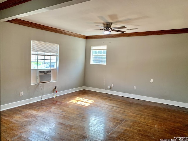 empty room featuring baseboards, dark wood-type flooring, visible vents, and crown molding