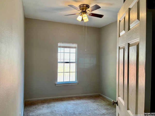 spare room with a ceiling fan, carpet flooring, and baseboards