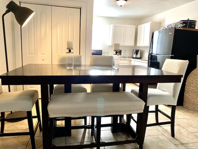 dining area with light tile patterned floors