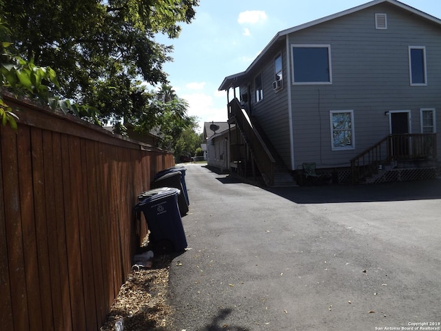 view of side of home featuring fence