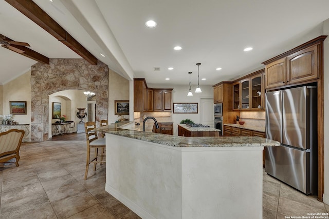 kitchen featuring arched walkways, lofted ceiling with beams, ceiling fan, glass insert cabinets, and stainless steel appliances