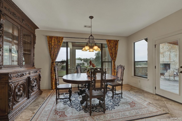 dining space with baseboards, visible vents, and a notable chandelier