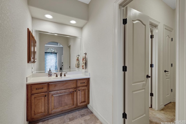 bathroom featuring recessed lighting and vanity