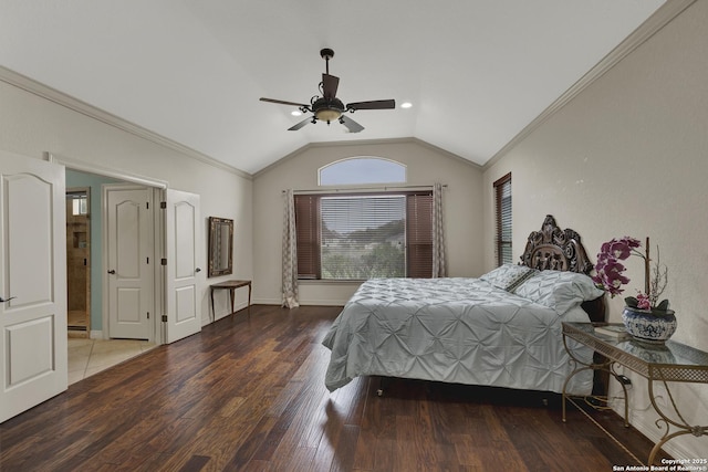 bedroom with ornamental molding, lofted ceiling, baseboards, and wood finished floors