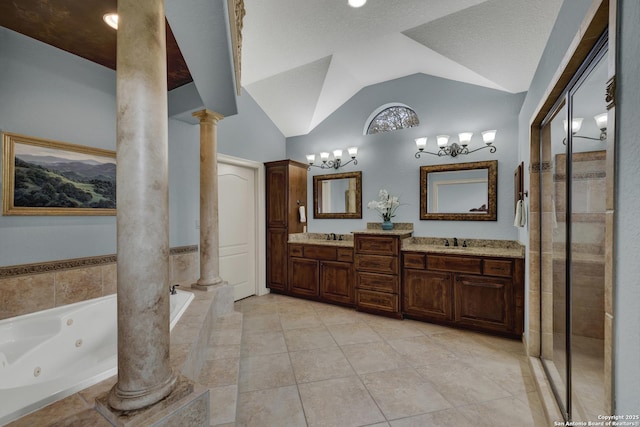 full bathroom with double vanity, a whirlpool tub, tile patterned flooring, vaulted ceiling, and ornate columns