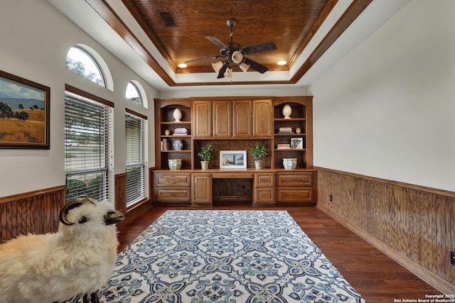 office featuring dark wood-style floors, a tray ceiling, a wainscoted wall, wooden walls, and wooden ceiling