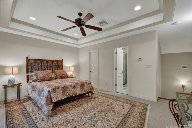 bedroom with a raised ceiling, visible vents, and crown molding