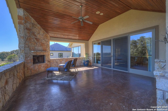 view of patio / terrace with ceiling fan and an outdoor stone fireplace