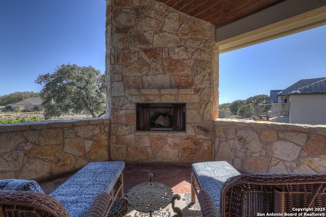 view of patio featuring an outdoor stone fireplace