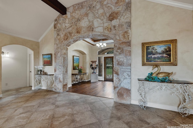 entrance foyer with ornamental molding, arched walkways, beamed ceiling, and high vaulted ceiling