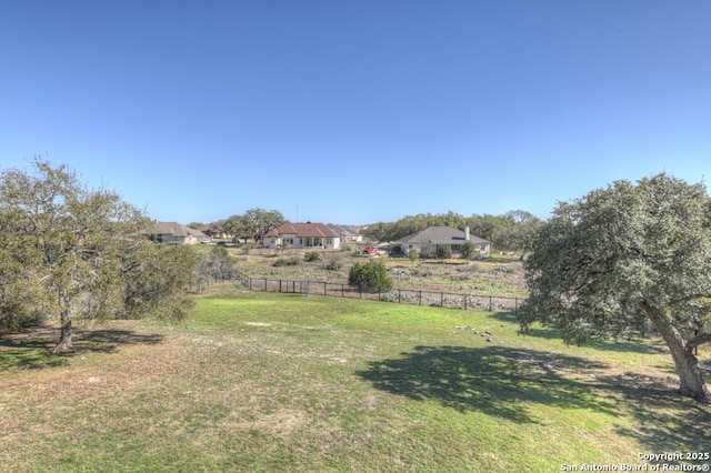 view of yard with a rural view and fence