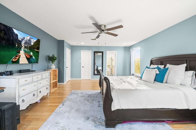 bedroom featuring visible vents, baseboards, ensuite bath, light wood-style flooring, and ceiling fan