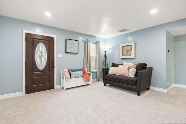 living room featuring light carpet, baseboards, visible vents, and recessed lighting