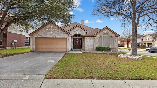 french provincial home with brick siding, a chimney, an attached garage, driveway, and a front lawn