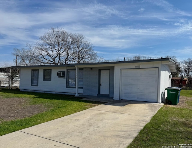 single story home with driveway, a garage, a wall mounted air conditioner, and a front yard