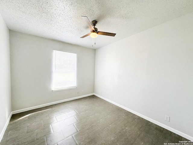 unfurnished room featuring a ceiling fan, a textured ceiling, and baseboards