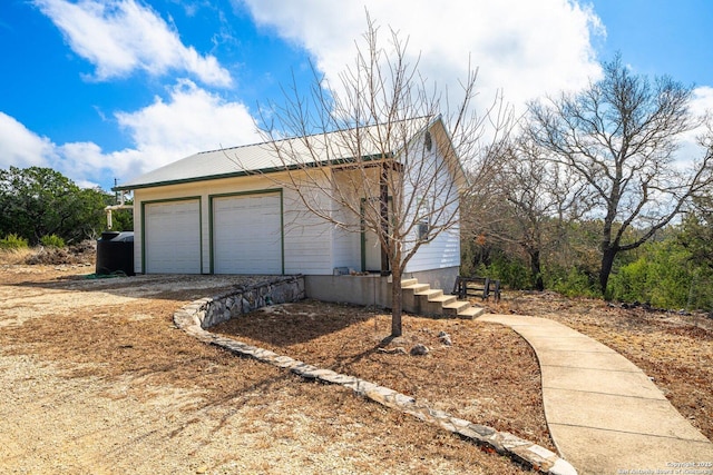 view of home's exterior with a detached garage