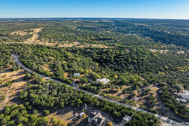 birds eye view of property with a wooded view