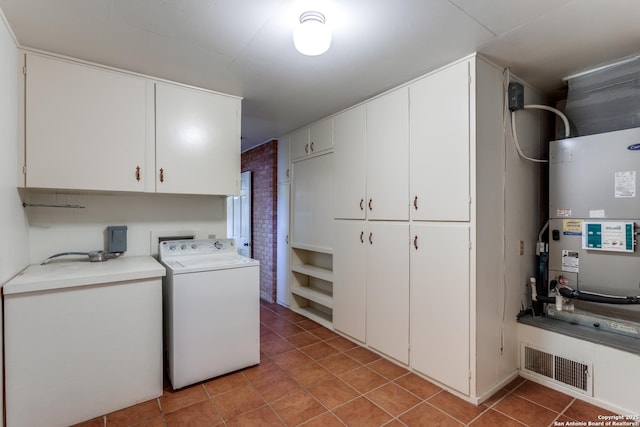 clothes washing area featuring light tile patterned floors, visible vents, cabinet space, heating unit, and washer / clothes dryer