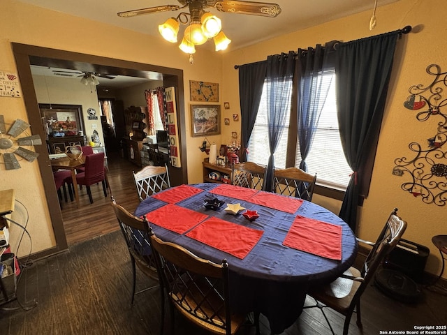 dining area with dark wood finished floors and ceiling fan