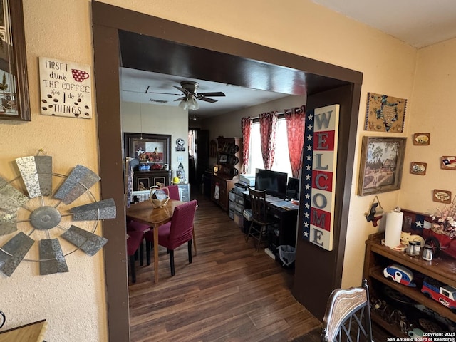 interior space featuring dark wood-style floors, visible vents, and ceiling fan