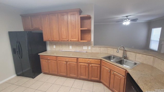 kitchen featuring light countertops, black appliances, a sink, and brown cabinets