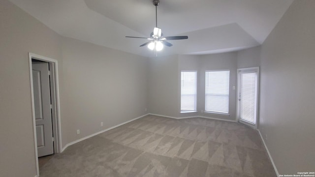 empty room featuring light carpet, baseboards, and a ceiling fan