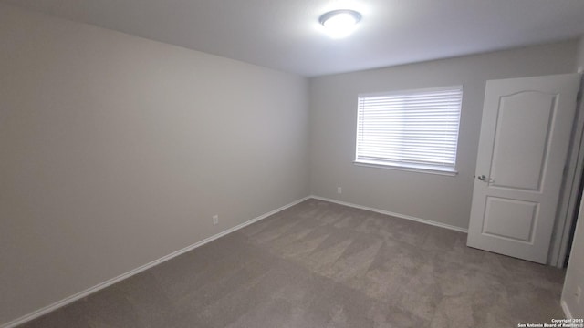 spare room with carpet floors and baseboards