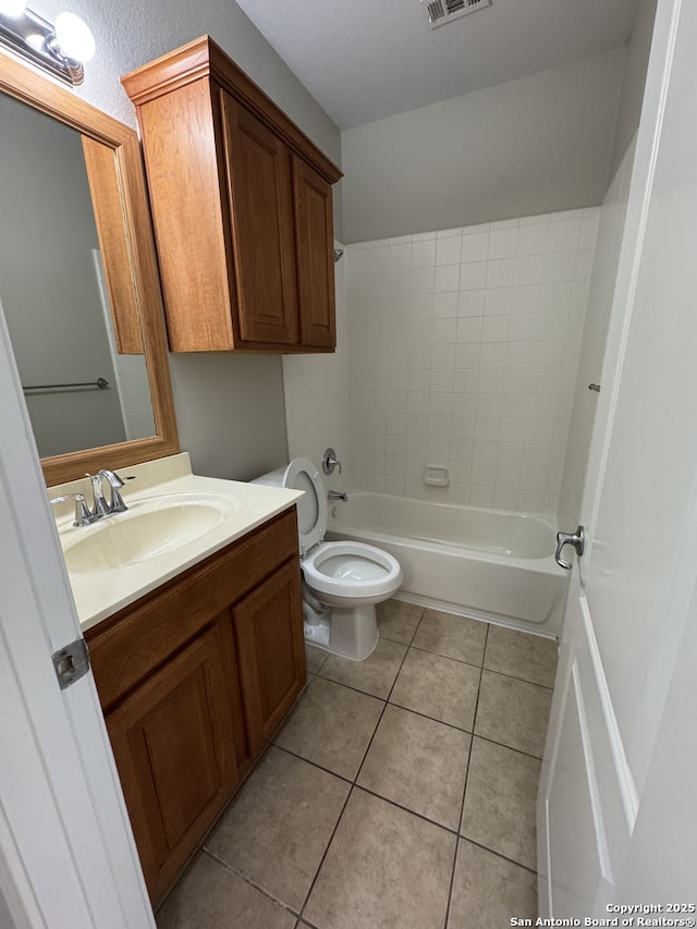 full bathroom with visible vents, toilet, vanity,  shower combination, and tile patterned flooring