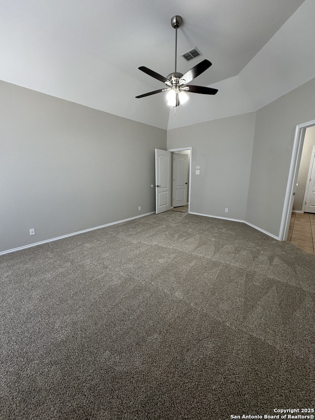 unfurnished bedroom featuring baseboards, visible vents, a ceiling fan, lofted ceiling, and carpet floors