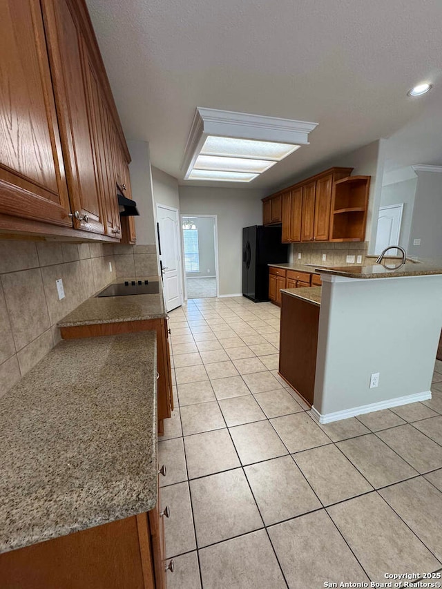 kitchen with light tile patterned flooring, black appliances, brown cabinets, open shelves, and tasteful backsplash