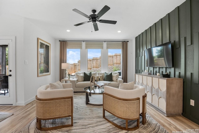 living area with ceiling fan, light wood finished floors, baseboards, and recessed lighting