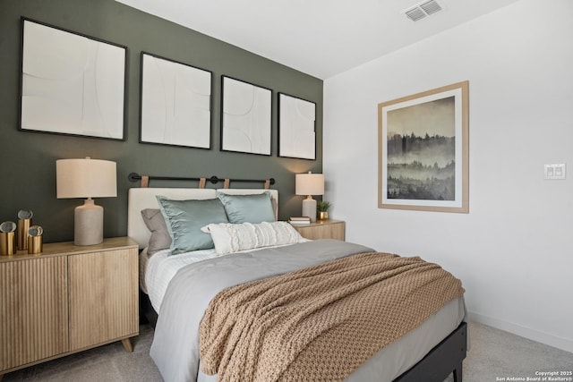 bedroom with baseboards, visible vents, and light colored carpet