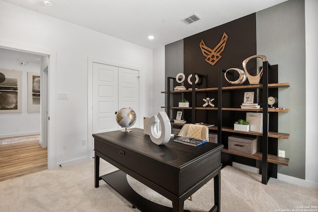 office space with recessed lighting, visible vents, light carpet, and baseboards