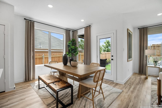 dining room featuring light wood-style flooring, baseboards, and recessed lighting