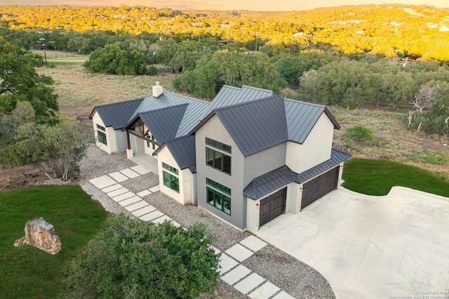 drone / aerial view with a wooded view