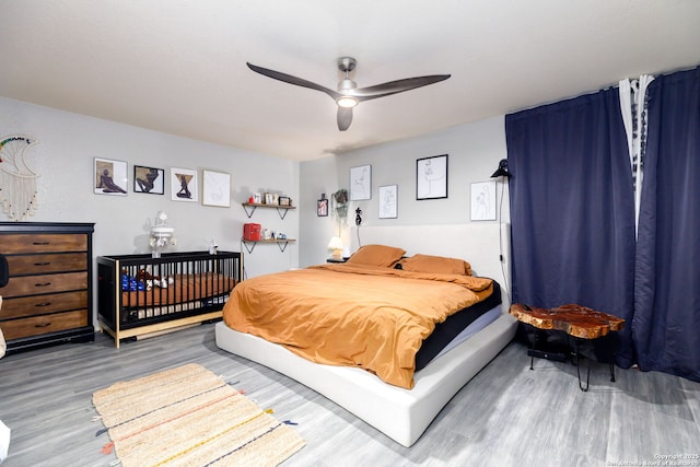 bedroom with wood finished floors and a ceiling fan